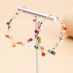 colorful crystal earrings hanging on a silver pillar