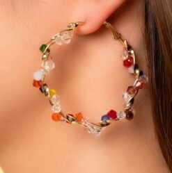 woman wearing colorful crystal earrings