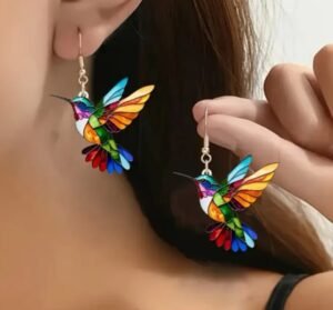 woman with brown hair wearing colorful earrings