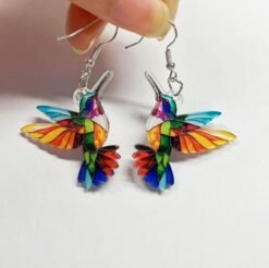woman holding colorful earrings for women