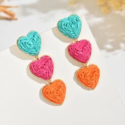 colorful heart-shaped earring placed on the white surface