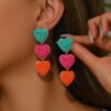 woman wearing colorful heart-shaped earrings