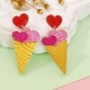 colorful ice cream earrings lying on a white and green table