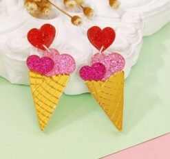 colorful ice cream earrings lying on a white and green table