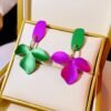 colorful statement earrings in a beige jewelry box