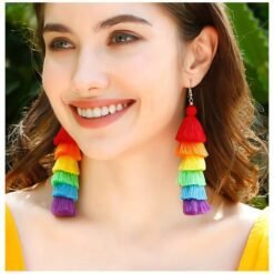 woman with brown hair and green eyes wearing colorful tassel earrings and smiling widely