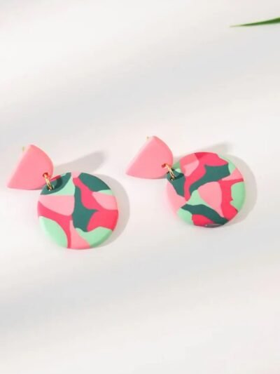 side view of colorful round earrings on the white background