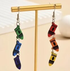 fun colorful earrings hung on a golden jewelry pillar