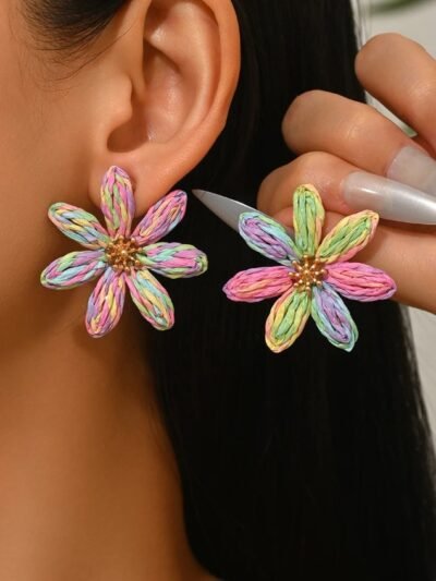 woman with dark brown hair wearing multicolored flower earrings