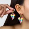 woman with black hair wearing romantic colorful earrings