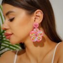 woman with dark brown hair wearing spring colorful earrings