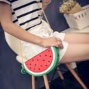 woman wearing watermelon bag, white shorts and striped shirt