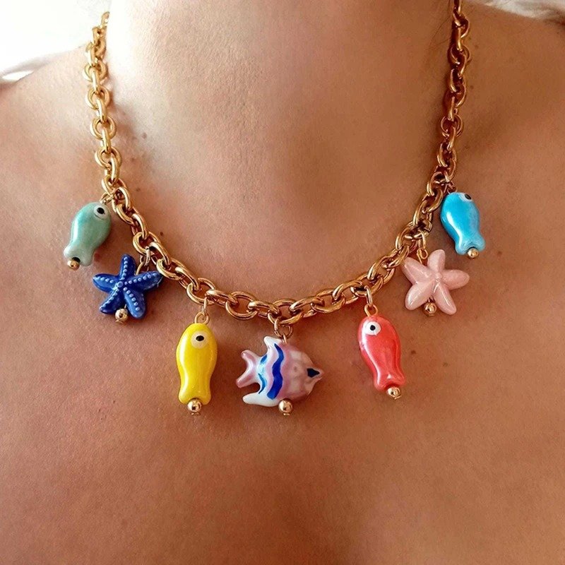woman wearing ceramic colorful fish necklace
