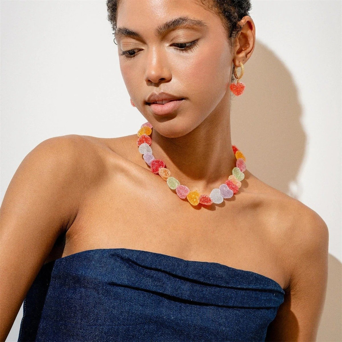 woman wearing colorful candy necklace and a navy blue evening dress