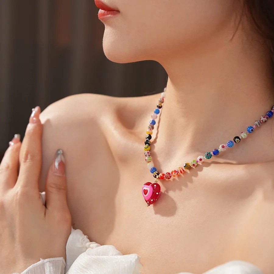 woman wearing colorful glass necklace and a white top