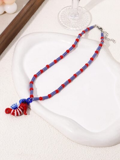 colorful seahorse necklace on the white silky fabric