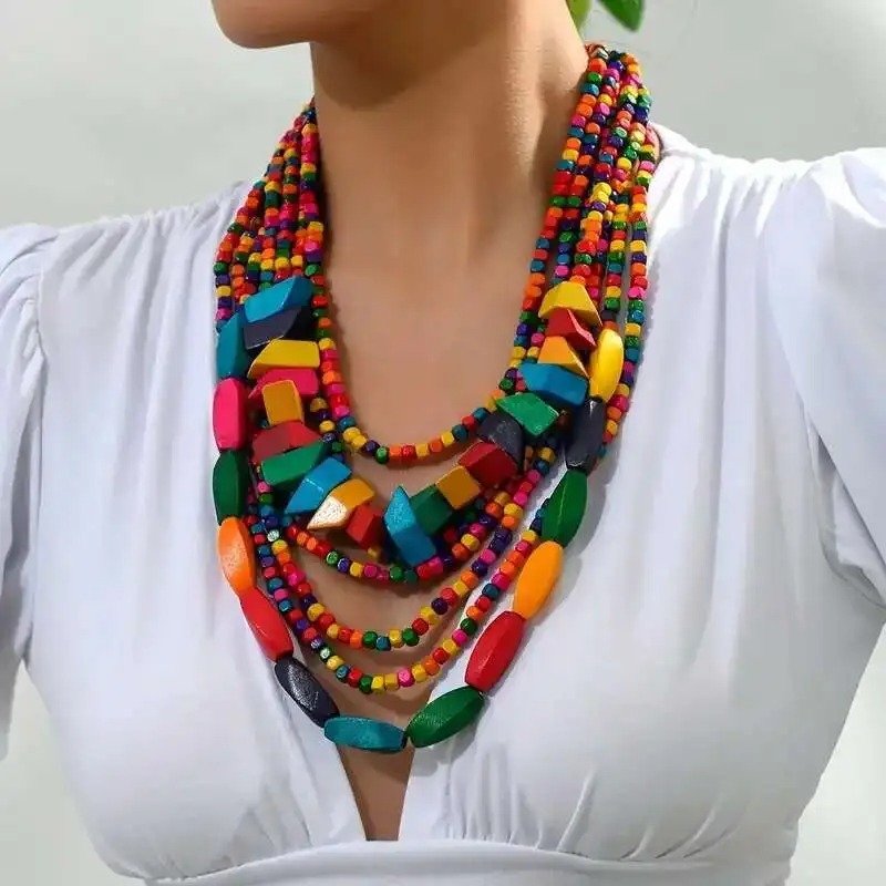 woman wearing colorful wooden necklace and a white blouse