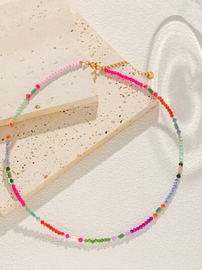 multicolor beaded necklace on the beige and white background