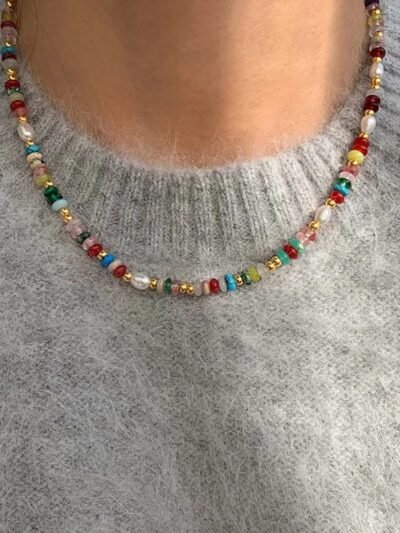 woman wearing retro colorful necklace and a grey sweater