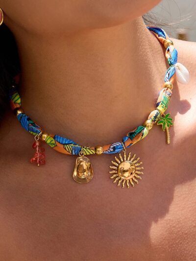 woman wearing colorful scarf necklace and pink earrings