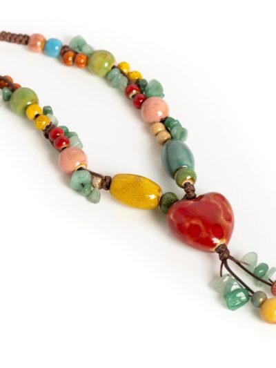 beads and brown rope of multicolored beaded necklace on the white background
