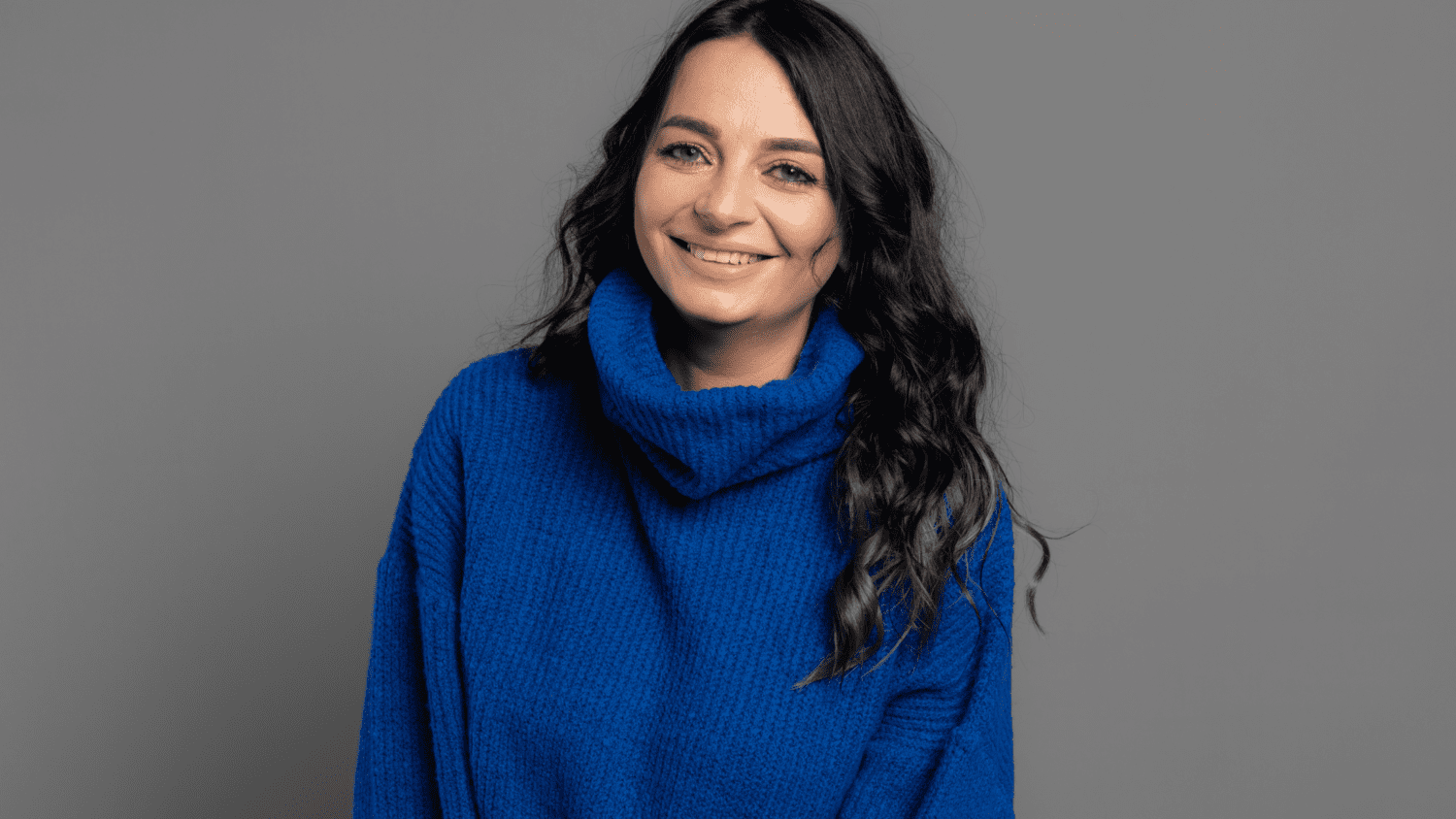 woman wearing a dark blue sweater and smiling